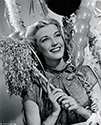 Anita Louise, Columbia Studios star, needs no encouragement as she stands ready to celebrate the New Year, 1946. At the time of this photograph, she was starring in 'The Bandit of Sherwood Forest'
