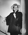 Columbia Studios dancer Ann Miller models this new fur design by Willard George of Los Angeles. The jacket design includes a short black Persian creation with swing back and tuxedo front. This photograph was used to support her role in Columbia Studios dance thriller, “The Thrill of Brazil”, directed by S. Sylvan Simon, 1945.