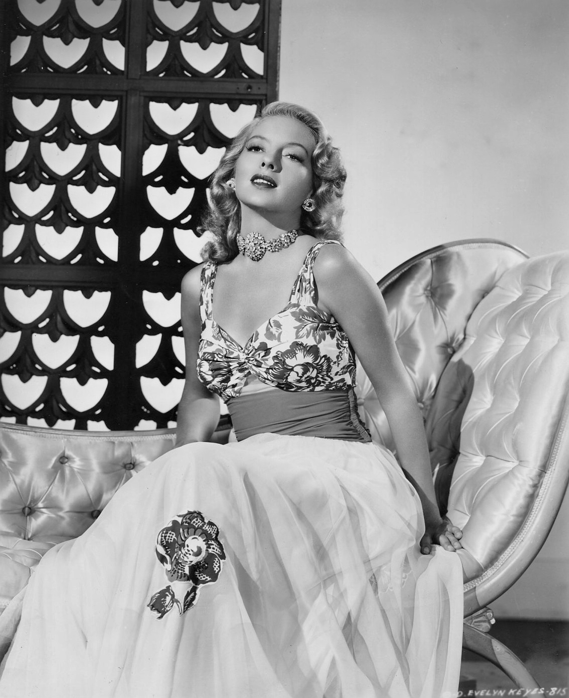 Evelyn Keyes poses for a lavish fashion statement to support her role in Director Henry Levin's romantic comedy, "The Mating of Millie", 1948.