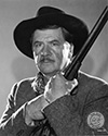 Stagecoach 1939 film: A portrait of George Bancroft as U.S. Marshall "Curly" Wilcox in John Ford's epic Western drama, "Stagecoach". Walter Wanger Productions staff members applied this caption on the back of this print in Ned Scott's personal collection: George Bancroft in the role of "Curly", a U.S. Marshall, in Walter Wanger's production "Stagecoach". Bancroft again plays the type of character that has made him famous--a rugged, two-fisted he-man. This production marks the 14th anniversary since climbing to stardom". Director John Ford's epic Western drama, "Stagecoach", 1939.