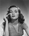 Gloria Henry photos: Ned Scott snapped this portrait photo of Gloria Henry as she prepares her make-up for one of roles in Columbia Pictures film in the late 1940's.