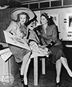 Both of these Columbia Girls posed to support their roles in the 1944 film, Cover Girl. The studio caption reads "...Susan Shaw and Jinx Falkenburg meet while playing themselves in Columbia Studios Rita Hayworth starrer, Cover Girl". Both are admiring a sketch of a new wardrobe ensemble by studio head designer, Jean Louis. Director Charles Vidor's musical comedy, "Cover Girl, 1944.
