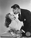 Franchot Tone and Janet Blair share a torrid moment in costume and onset for this nifty noir mystery film from Columbia Pictures. Tone plays the private eye Stuart Bailey who is hired by an aggrieved husband to find his wife who has gone missing, but in actuality, was murdered by the husband. Janet Blair plays the wife's sister who gets involved with Bailey more out of circumstance than true attraction. Director S. Sylvan Simon's film noir mystery, "I Love Trouble", 1948.