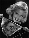  Janis Carter photo: While Janis Carter was filming for Columbia Studios' hit adventure comedy "A Thousand and One Nights",1945, Ned Scott invited her to his home in La Canada for a photo session. This compelling image is one of several to emerge from that effort. Janis is posing above a mirrored console table for dramatic effect. Director Alfred E. Green's romantic fantasy "A Thousand and One Nights", 1945.