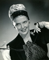 Janis Carter: Caption for this 1947 fashion print reads: "Higher and higher goes the hair this season, and pretty Janis Carter introduces a clever Dache' net in Normandy green that covers a head full of soft curls not yet dry. The band is black felt, studded with gold nail beads, as is her clever bag to match. This net enables Janis to go from hair dresser to her next engagement looking well groomed and attractive. Janis will soon be seen in a dramatic role in Columbia's 'The Fighting Guardsmen'."