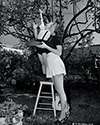 Jeff Donnell and her four year old son, Michael, picking fruit in their backyard on a sunny day in the Los Angeles area.