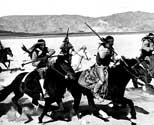 Navajo Indians, recruited to play the role of maurauding Apache Indians, ride to attack the coach in Walter Wanger's "Stagecoach". This scene was filmed at Lucerne Dry Lake near Victorville, California. The cayuse horses ridden in this scene belonged to the Navajos