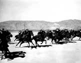 Stagecoach 1939 film: Cavalrymen rushing to the rescue of the passengers in the coach during filming of Walter Wanger's "Stagecoach". Filming for this scene took place in Lucerne Dry Lake near Apple Valley, California.
