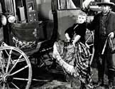 Stagecoach movie: "Tsk, tsk, tsk", Buck (Andy Devine), the stage driver, says to himself as Dallas (Claire Trevor) hurls a parting insult at he women who are forcing her out of town. "Stagecoach", under production by Walter Wanger and directed by John Ford, depicts the part these pioneer conveyances played in the lives of the people who rode them. Through sun and sleet, over prairie and desert and stagecaoch carried its human cargo and as it jounced and swayed over meager trails, it brought great changes in the lives of those who rode in them. To Dallas, the bitter outcast girl, it brought love and a new life. 