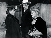 Stagecaoch 1939 film: Claire Trevor, as outcast girl Dallas, gets a sneer from the cavalry officer's wife, Lucy Mallory, played by Louise Platt and the Southern gentleman and arrogant gambler, Hatfield, played by John Carradine.