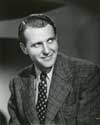 Ralph Bellamy photos: A portrait of Ralph Bellamy as the eager beaver detective Ben Blodgett with the San Francisco Police Department. He is assigned to the murder case in which Kay Karrigan, played by Joan Bennett, is accused, but escapes the Bay area by changing her hair color and jumping aboard an outward bound ship. Blodgett teams up with his old friend, the skirt chasing detective Sam Wye, played by Fredric March, and they both chase after the fugitive Kay Karrigan. Director Tay Garnett's lighthearted detective drama, "Trade Winds", 1939. 