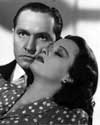 Fredric Marsh and Joan Bennett make their first screen appearance together in a fast-moving detective drama which takes the principals half way around the world. As Detective Sam Wye and accused murderer Kay Karrigan, Marsh and Bennett eventually wind up sharing a shipboard romance. Joan Bennett is seen throughout the greater part of the picture as a brunette after dyeing her hair as a means of eluding pursuit by the tenacious, skirt chasing detective. Director Tay Garnett's light hearted mystery drama, "Trade Winds", 1938.
