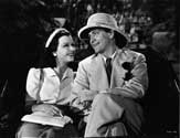 Joan Bennett and Fredric March join forces for the first time in a film of mystery, intrigue and far-flung places. Bennett plays accused murderer Kay Karrigan, and March plays the role of the detective who is determined to track her down after she escapes from San Francisco. Things change for the better along the way, however, as Sam's skirt chasing tendencies finally get the best of him. He and Kay share a shipboard romance and become friends as well as lovers. Here they enjoy a jinrikisha ride through the outkirts of Singapore. Director Tay Garnett's lighthearted mystery drama, "Trade Winds", 1938.