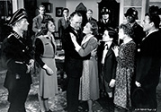 Nazi officers confront Walter Brennan who plays Professor Novotny, a noted historian and revolutionary figure who is taken into custody along with many other hostages in an effort to force the surrender of Karel Vanek (Brian Donlevy), the wanted assassin of Reich-Protector Reinhard Heydrich. This scene takes place in the Professor's own parlor with his family and servants standing as witnesses. Director Fritz Lang's wartime film noir drama, "Hangmen Also Die", 1943.