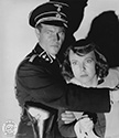 nna Lee is restrained in her horror and grief by Gestapo agent as she sees her father taken out to join others scheduled for execution. Director Fritz Lang's film noir wartime drama "Hangmen Also Die", 1943.