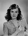A postrait of Paulette Goddard to support her role as Molly McKorkle, a young and beautiful Irish girl. Molly crosses paths with Jimmy Haskel, a down and out musician who has just failed in a music business. Things get complicated when Jimmy starts work for his cranky uncle, C.J. Haskel (Charles Winninger) who owns a health food business and hates music. Molly's family runs an in-house band that needs a little help. Jimmy finds it irresistable to do his best to help Molly's family, thereby improving his chances with the pretty Irish girl. Director George Marshall's romantic, musical comedy, "Pot O' Gold". 1941