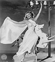 Rita Hayworth photos: The studio caption for this photograph reads: "Hayworth and Horse: Columbia’s glamorous redhead, Rita Hayworth can dance any place, and here she’s shown doing so on a carousel, for a big production number in the Technicolor "Down To Earth". This marks Rita’s return to the lavish musical picture after her dramatic role in "Gilda". Wearing the costume of Terpsichore, the Greek demigoddess of song and dance, Rita demonstrates in classic fashion the sweeping moves of Columbia’s dance director Jack Cole. Rita Hayworth photographs such as this one spawned the moniker the "Love Goddess", a production nickname which remained with Rita throughout her professional career. Director Alexander Hall’s musical and dance fantasy, "Down To Earth", 1947.