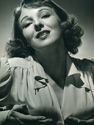 Ned Scott captured Anna Lee in a playful moment in this portrait which supports her role in the Arnold Pressburger production "Hangmen Also Die", 1943. Anna Lee plays the role of Masha Novotny, daughter of esteemed professor Stephen Novotny of Progue, Checkoslavakia, played by Walter Brennan. Just after Adolph Hitler had just finished commandeering the country in a bloodless coup, Reinhold Heidrich was installed as Reichprotector of the region. He was later assasinated by Check nationals, and it is this assasination which drives the energy of the film. Director Fritz Lang's dramatic wartime drama, "Hangmen Alo Die", 1943.