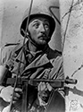 Robert Mitchum plays the much respected Lieutenant Walker, here standing at the ready with his 50 cal Thompson machine gun. Lt. Walker is killed in action during the battle for Sicily in 1942. Director William Wellman"s "The Story of G.I. Joe", 1945.