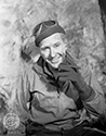 Burgess Meredith portrays a relaxed Ernie Pyle, cigar in hand, somewhere on the front lines in Northern Africa during Operation Torch in Director William Wellman's biographical wartime drama, "The Story of G.I. Joe", 1945. 
