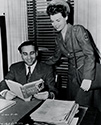 Cadet Nurse Beulah Tyler reviews Ernie Pyle's book Here Is Your War with independent film Producer Lester Cowan on the set of The Story of G.I. Joe. This office was located at Selznick Internatinal Studios in Culver City, California.