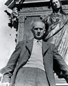 Ernie Pyle poses for Ned Scott under the bas-relief statue of the Virgin Mary. Nothing was suggested by Ned Scott when he posed Ernie for this image, just the form complemented the man. Though Ernie looks larger here, he only weighed in at 110 pounds.