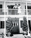 Gene Autry and his wife smile a greeting from the balcony of their home in San Fernando Valley. This photograph supported Columbia's film 'The Strawberry Roan', 1948.