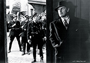 Nazis search the town for assassin Karel Vanek, played by Brian Donlevy, who has just successfully killed Reich-Protector Reinhard Heidrich, alias The Hangman